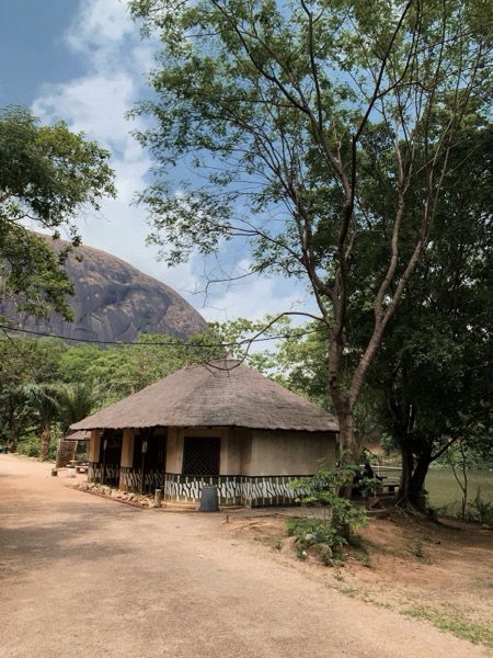Thatched hut with rock formation