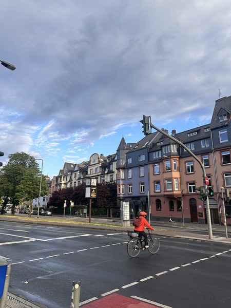 Cyclist in red jacket on city street